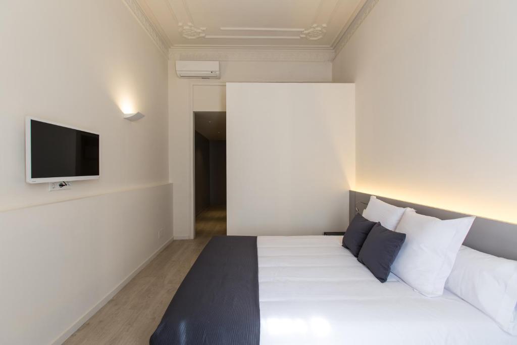 Postel nebo postele na pokoji v ubytování Izaila Plaza Catalunya