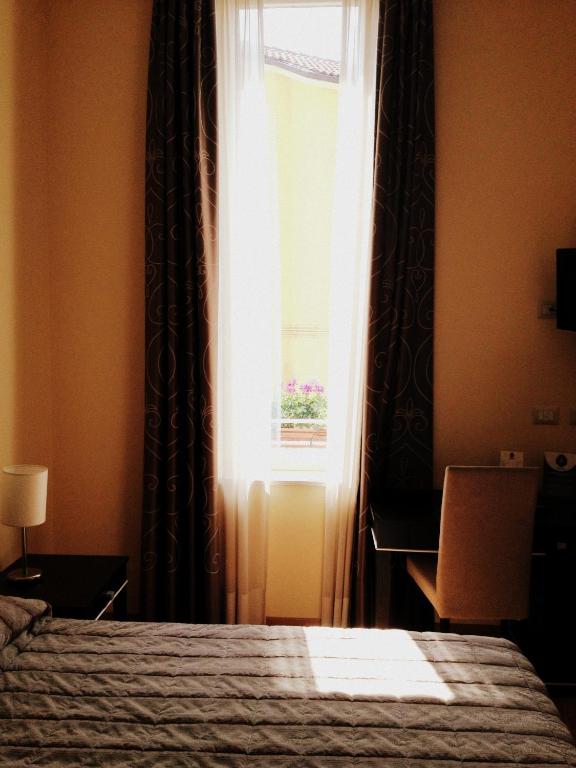 Postel nebo postele na pokoji v ubytování Hotel Villa Cinzia