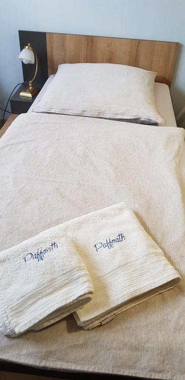 two towels sitting on top of a bed at Pension K61 Sylke und Michael Paffrath in Gebesee