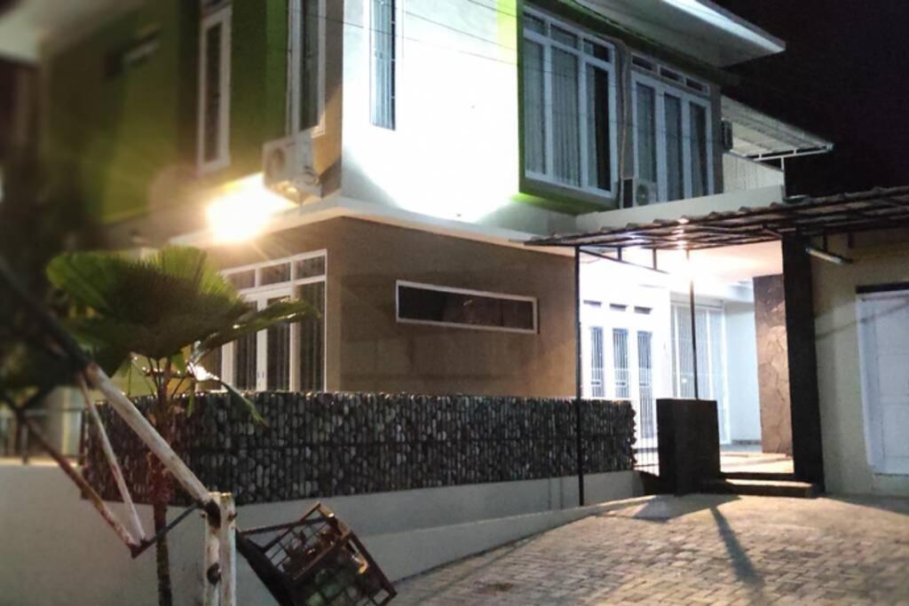 a building with a fence in front of it at night at Shakilla House 1A Syariah in Cianjur