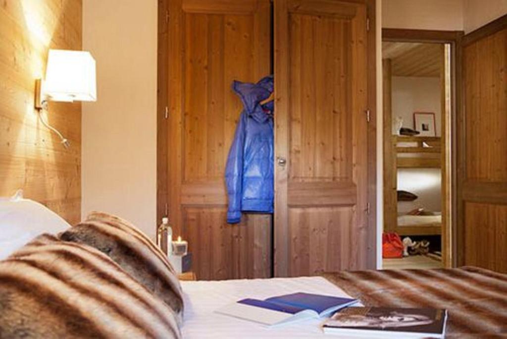 a blue robe hanging on a door in a bedroom at Résidence - Les Grandes Alpes in La Clusaz