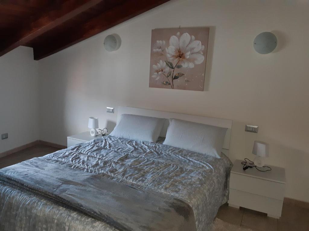 Łóżko lub łóżka w pokoju w obiekcie B&B La Genuina