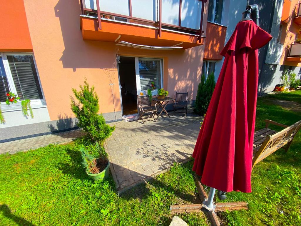 a red umbrella in the yard of a house at 3 Bedroom apartment in the part of the city in Banská Bystrica