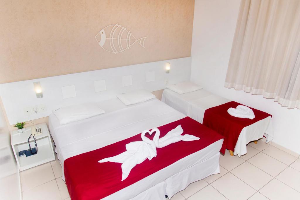 Cama ou camas em um quarto em Pousada Pérola Dourada