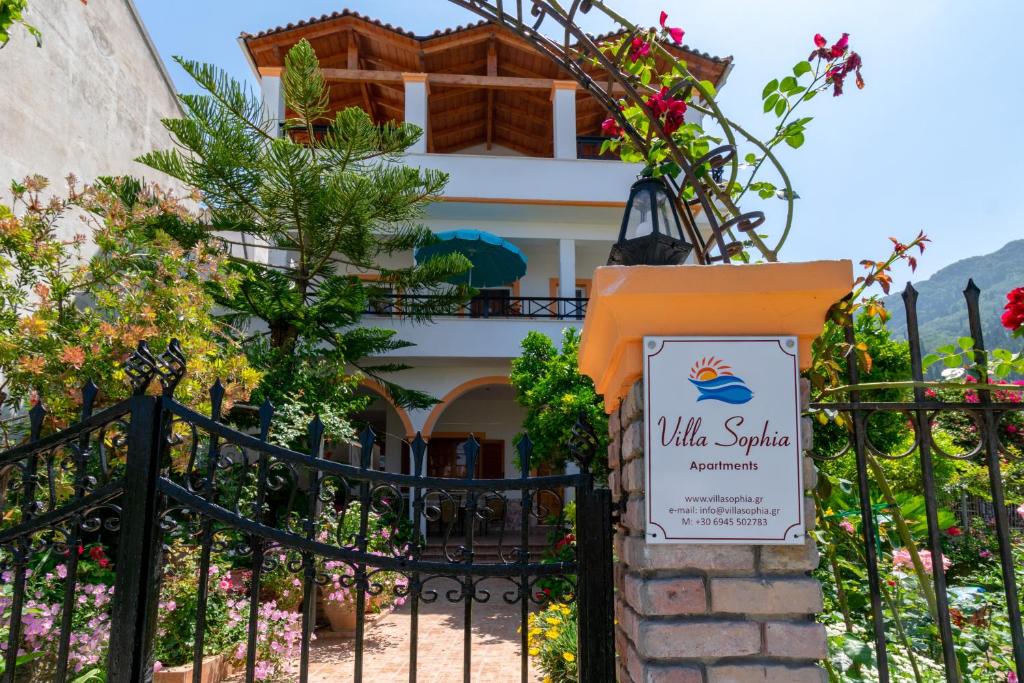 a gate to a villa with a sign in front of it at Villa Sophia Apartments by CorfuEscapes in Agios Gordios