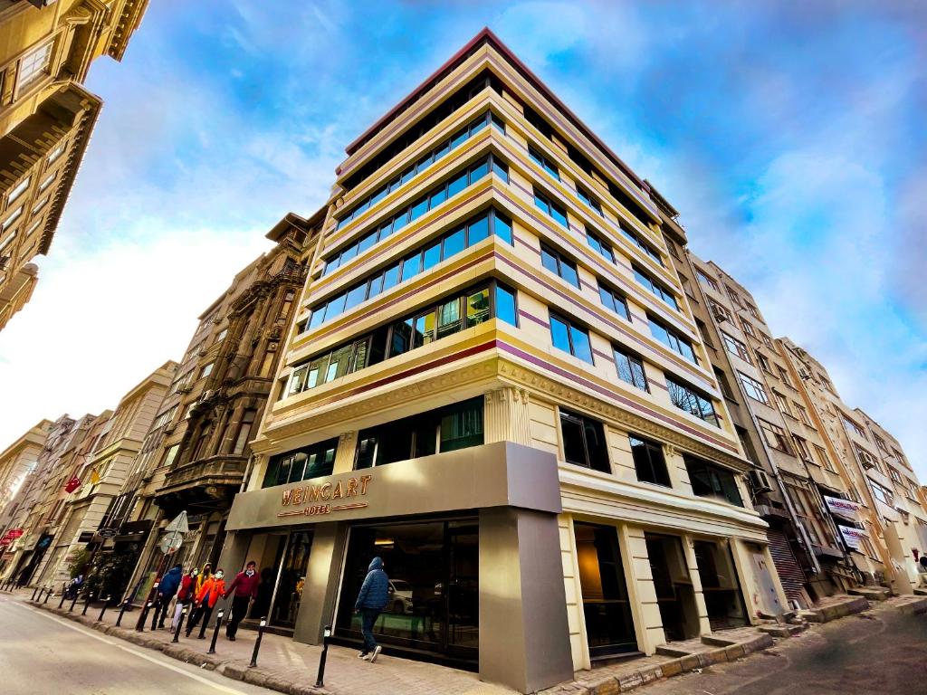 a tall building with people standing in front of it at Weingart Istanbul in Istanbul