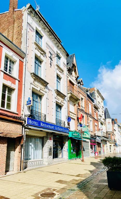 a building with a sign on the side of a street at Best Western Hotel Saint Claude in Péronne