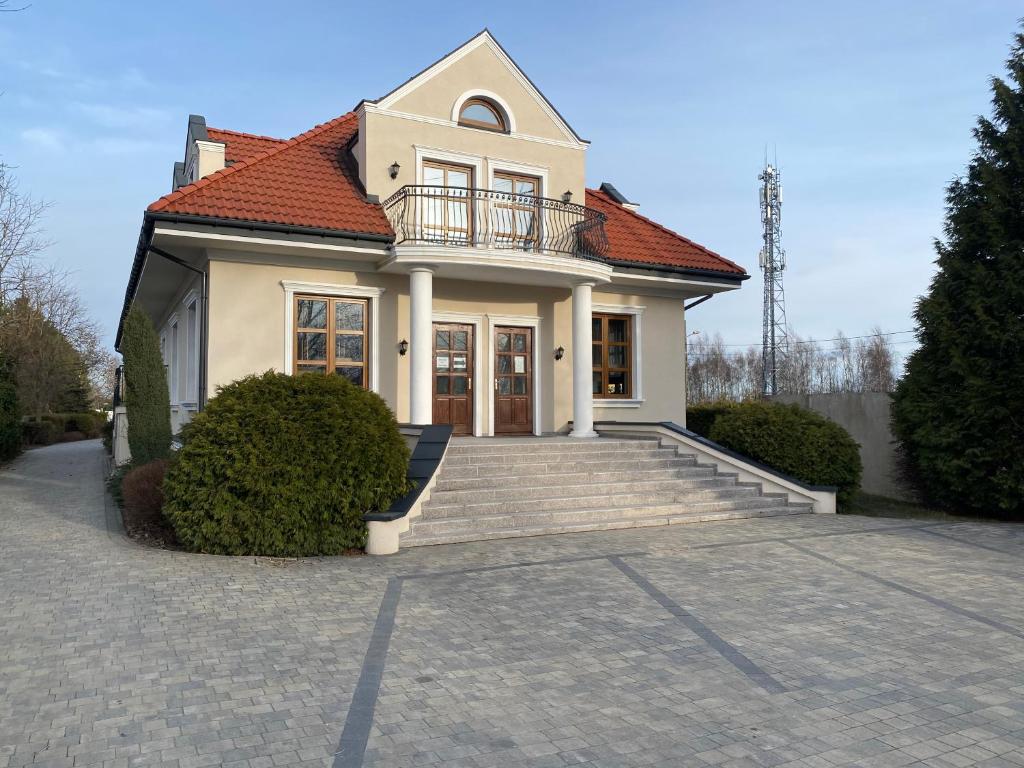 a house with a staircase in front of it at Zielony Dworek in Częstochowa