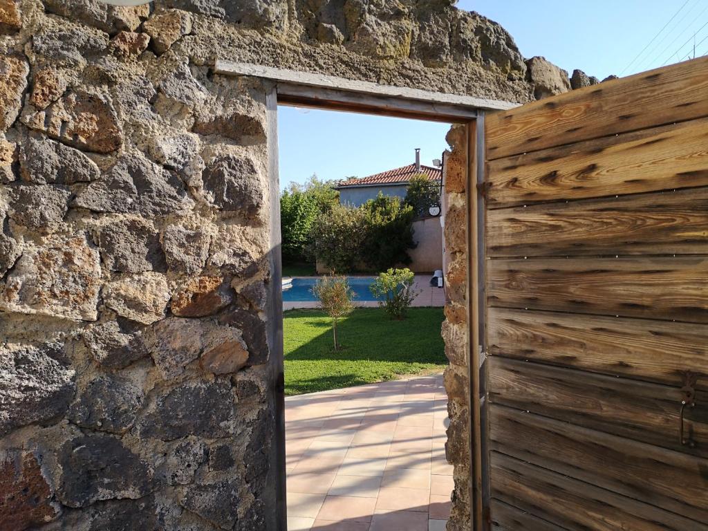 an open door into a stone building with a stone wall at MAISON DE CARACTERE POUR 6 PERS AVEC PISCINE in Agde