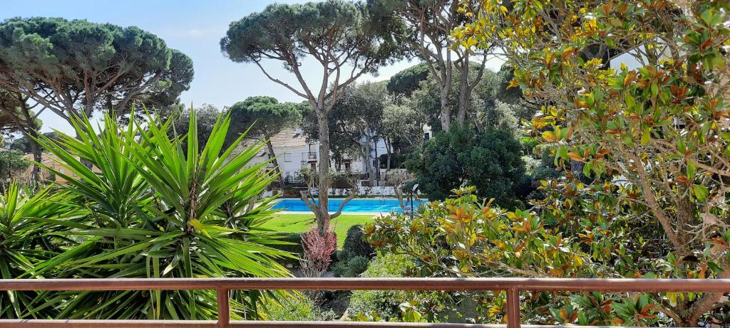 a view of a garden with trees and a pool at Apartamento de standing Calella de Palafrugell in Calella de Palafrugell