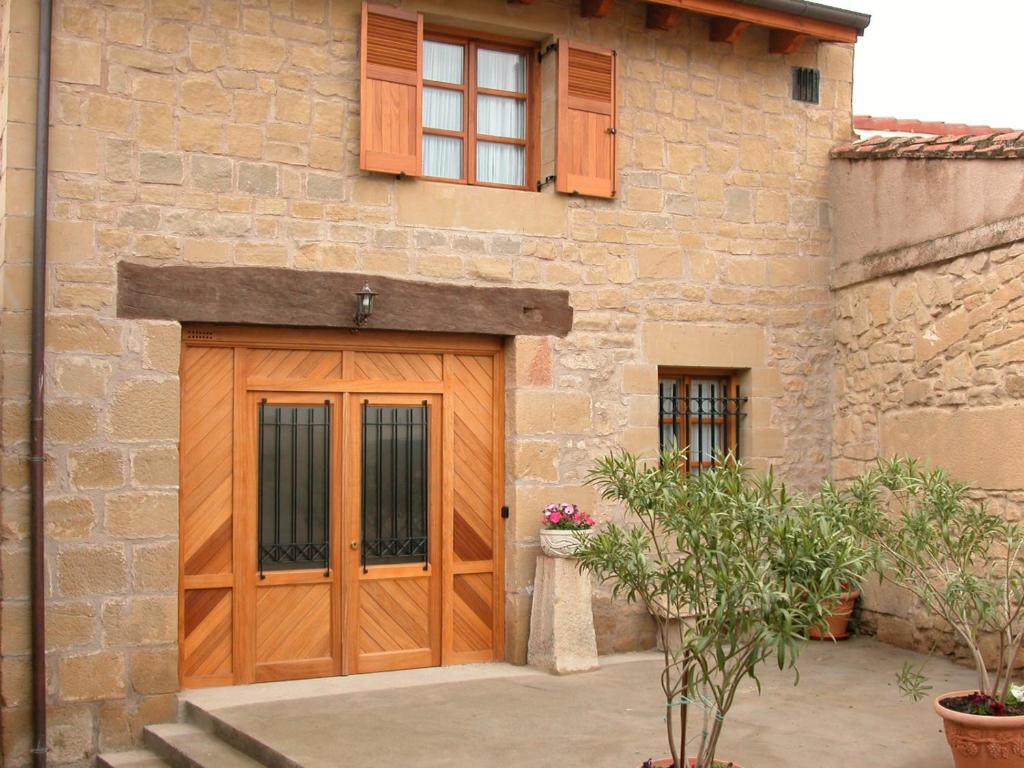 a wooden garage door on a stone building at La cueva in Elciego