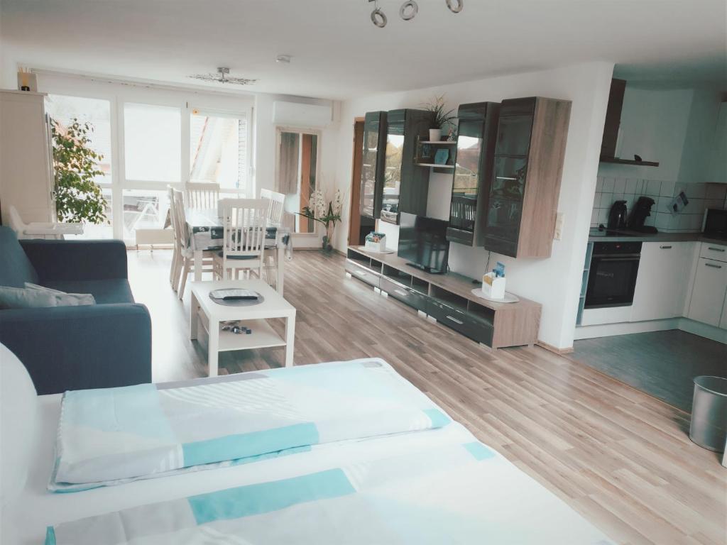 a living room with a blue couch and a kitchen at Ferienwohnung Sobichowski in Rust