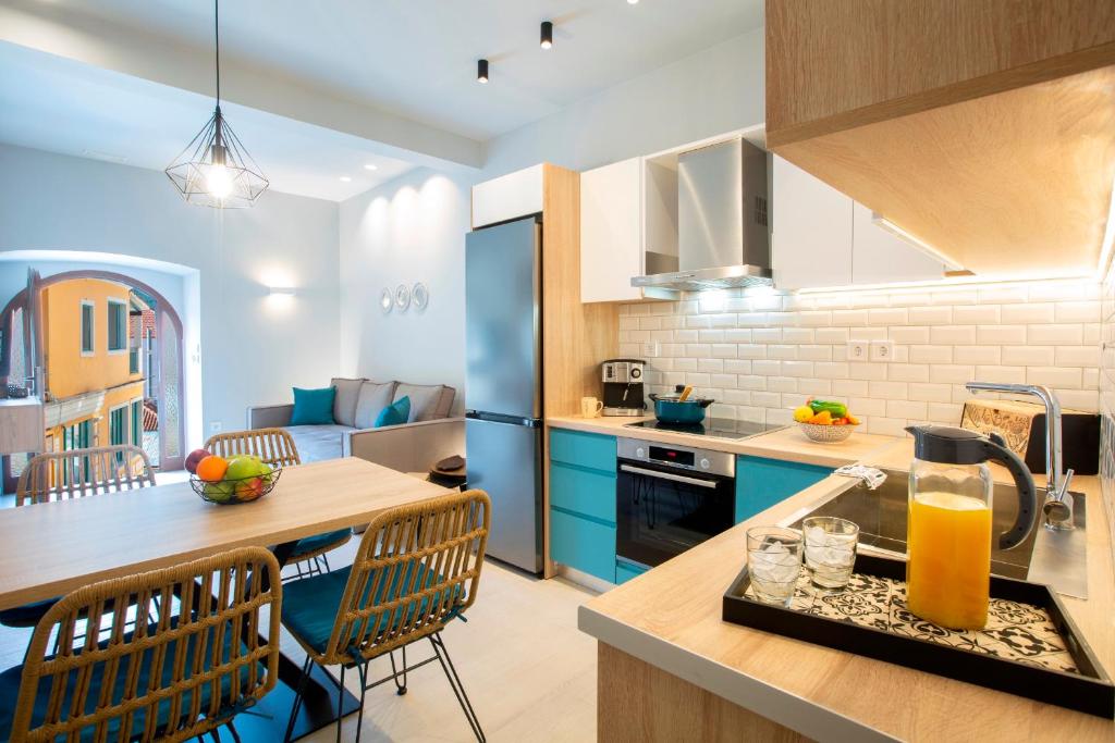 a kitchen with blue cabinets and a table with a blender at George's Home in Vasiliki