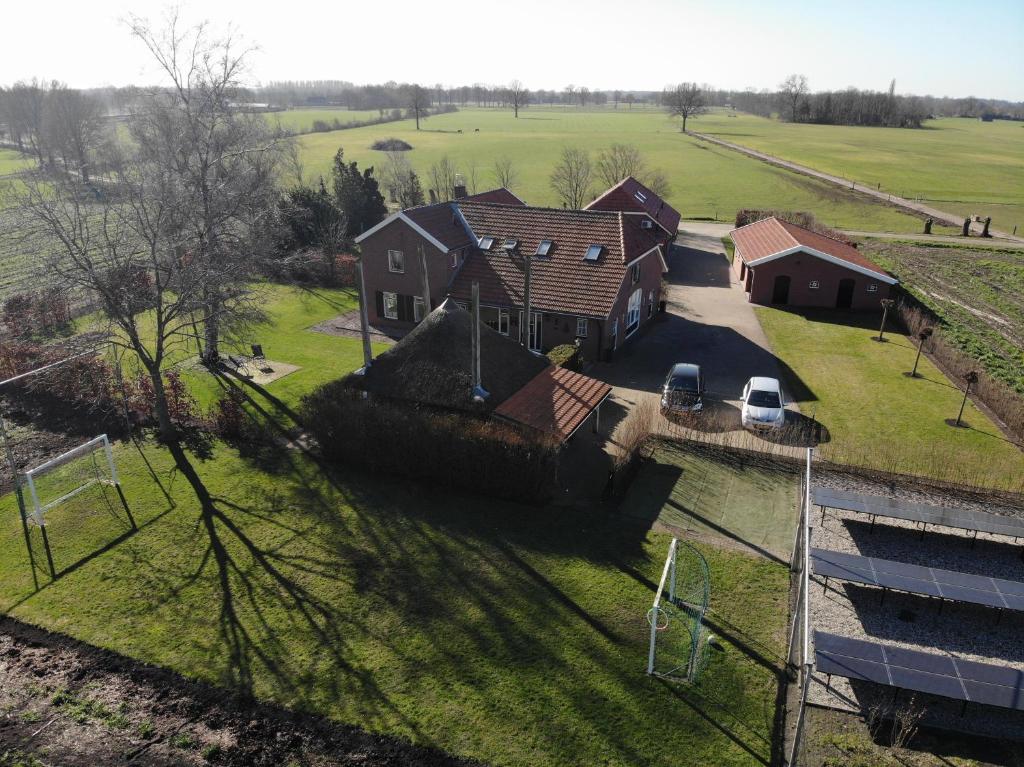 an aerial view of a house with a yard at De Achterkoert in Halle