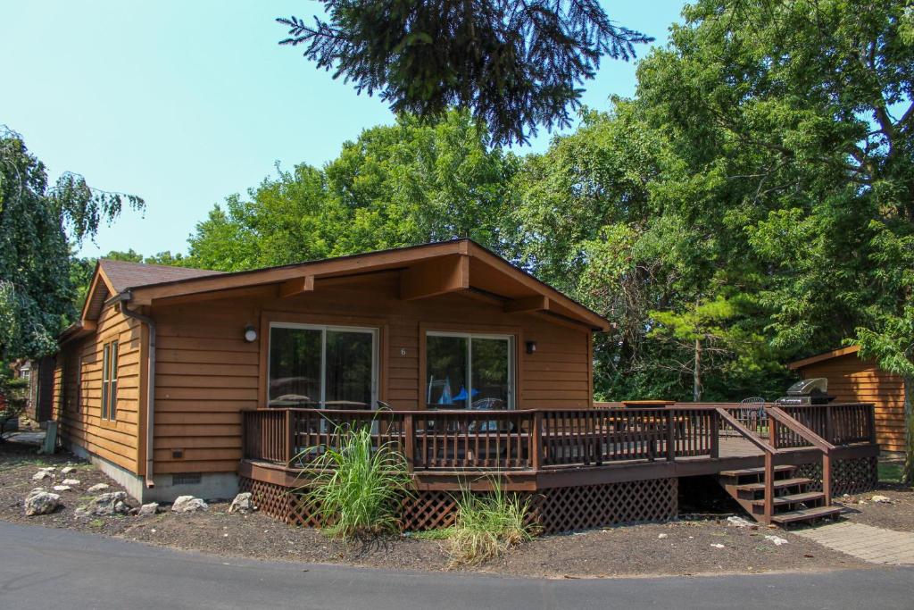 a log cabin with a porch and a deck at Island Club #6 in Put-in-Bay