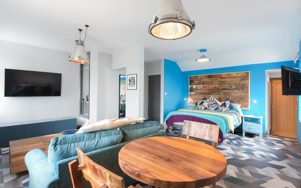 sala de estar con sofá, mesa y cama en Farne Island Bed and Breakfast, en Seahouses