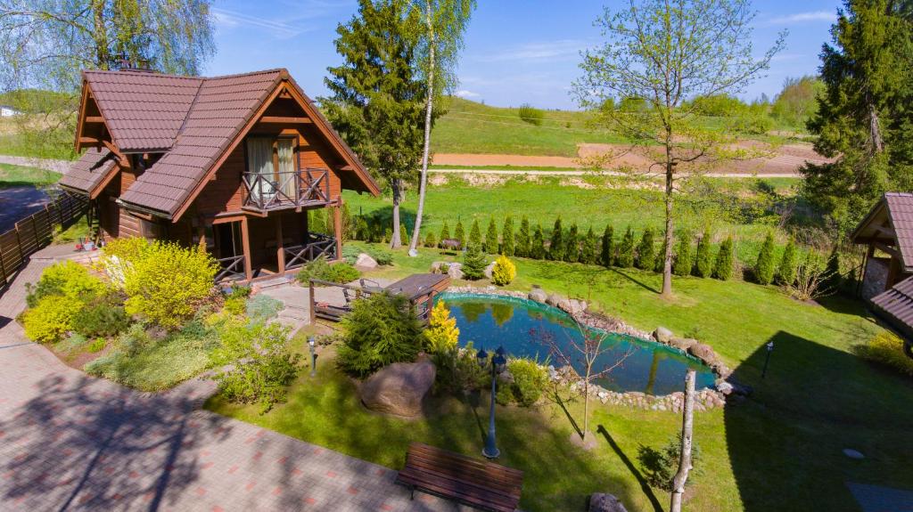 an aerial view of a house with a swimming pool at Rustic private Cabin in woods w/ Sauna & Pool in Vilnius