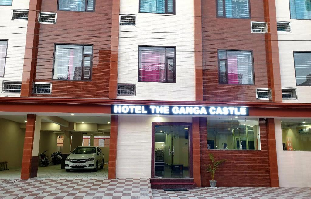 a hotel with a car parked in front of it at Hotel The Ganga Castle in Haridwār