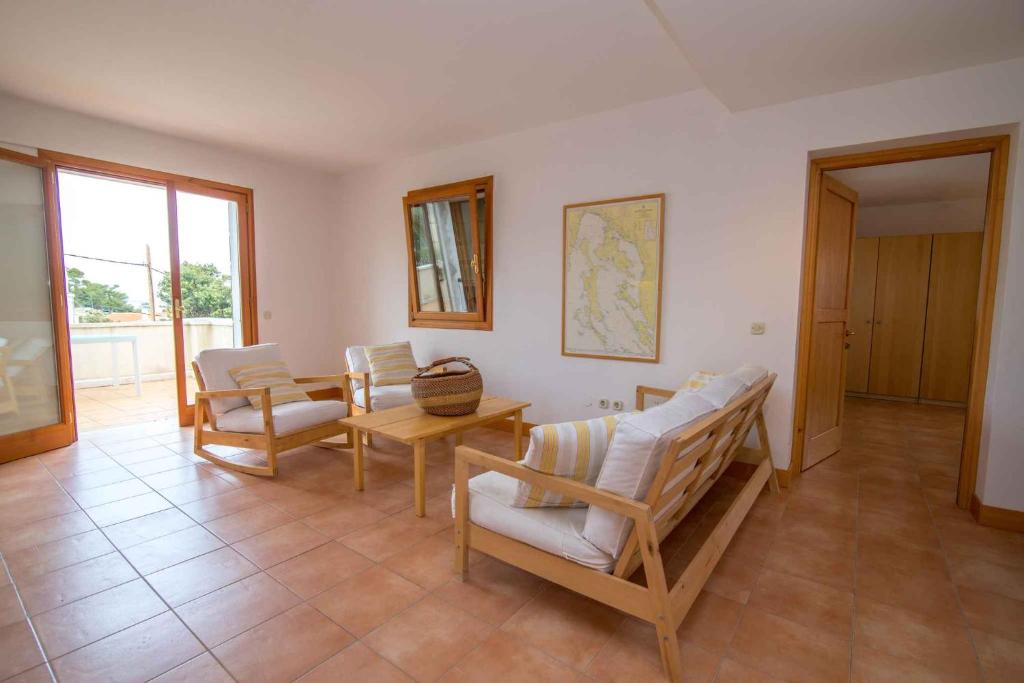 a living room with a table and chairs at Apartment in Veli Losinj 36588 in Veli Lošinj