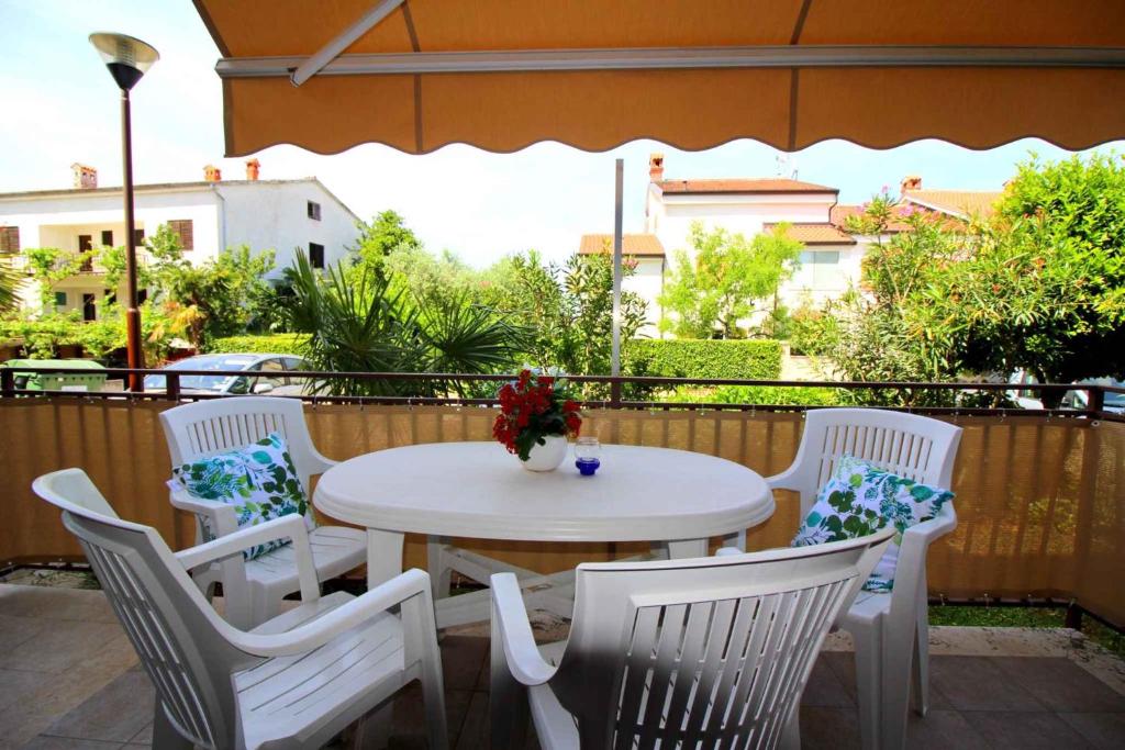 a white table and chairs on a patio at Apartment in Porec/Istrien 36682 in Poreč