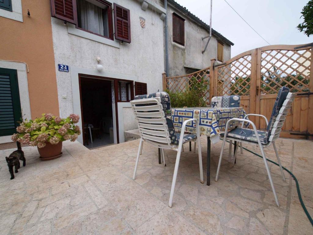 a table and chairs sitting on a patio at Apartment in Veli Losinj 26456 in Veli Lošinj