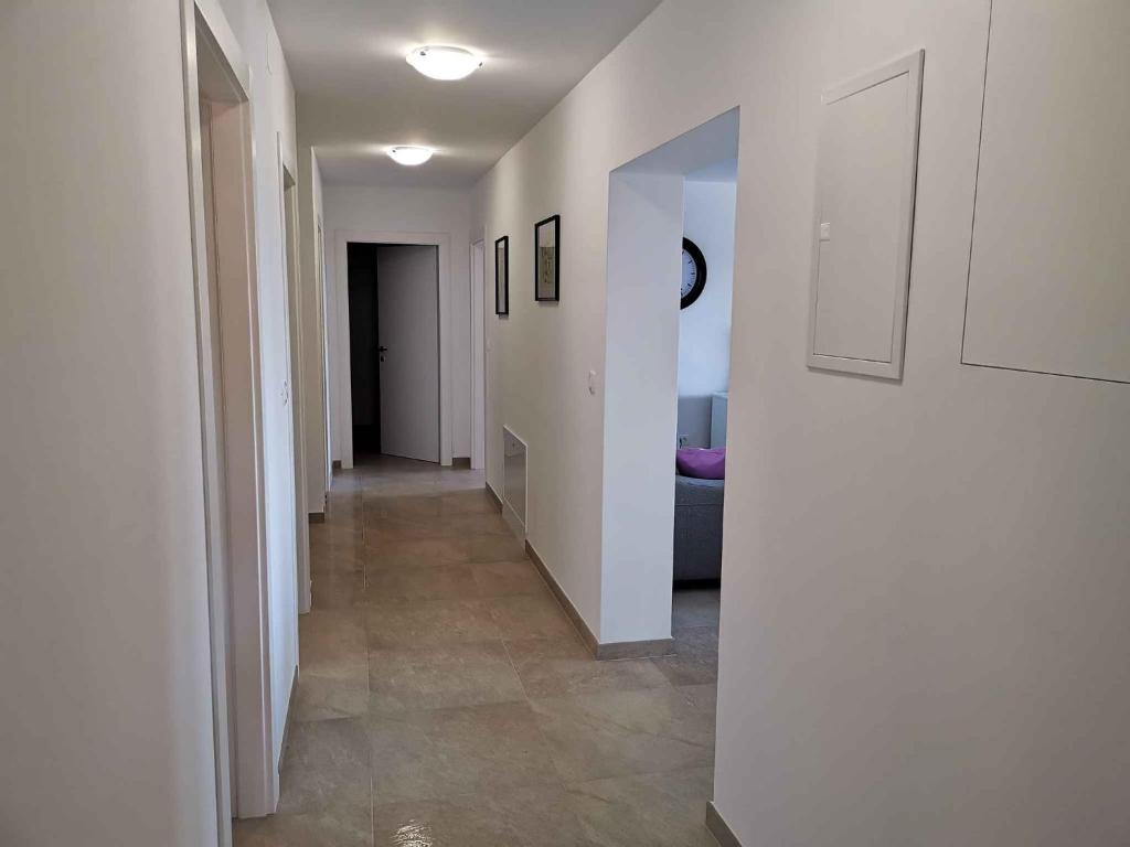 a hallway with white walls and tile floors in a house at Apartment in Crikvenica 34973 in Sopaljska