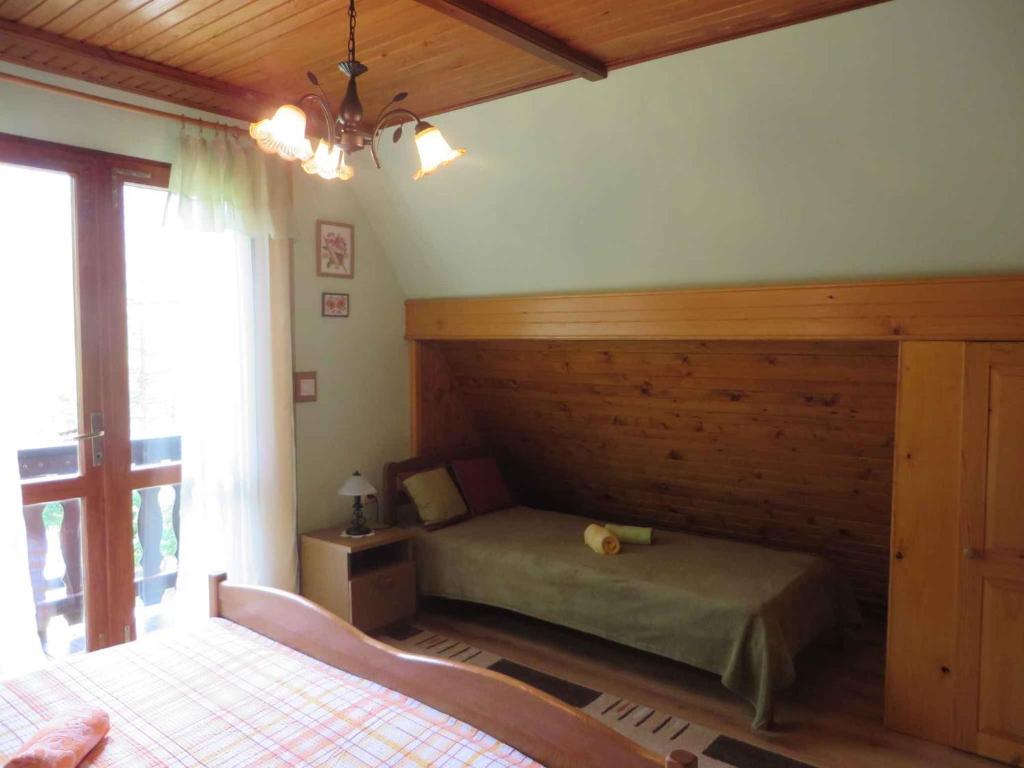 a bedroom with two beds and a window in a room at Holiday home in Turke/Gorski Kotar 34884 in Turke