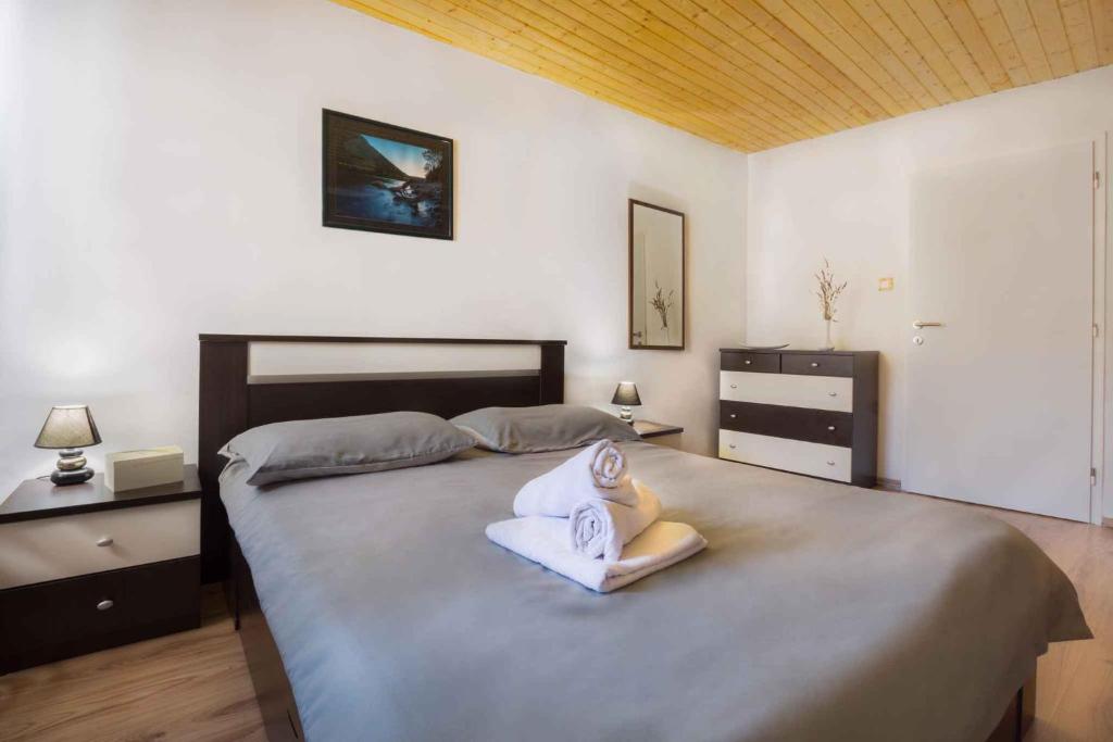 a bedroom with a bed with a swan decoration on it at Holiday home in Krsan 34373 in Kršan