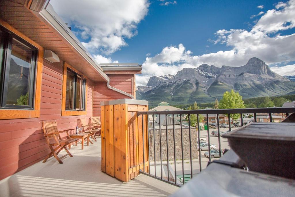 a balcony with chairs and a view of a mountain at RidgeView Loft - Top Floor 2 Bed 2 Bath, Amazing Views in Canmore
