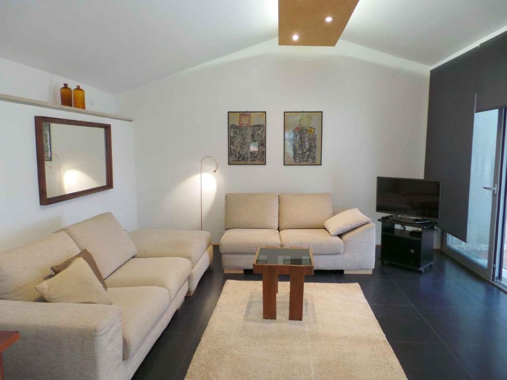 a living room with two couches and a tv at Apartments in Rovinj/Istrien 34602 in Rovinj