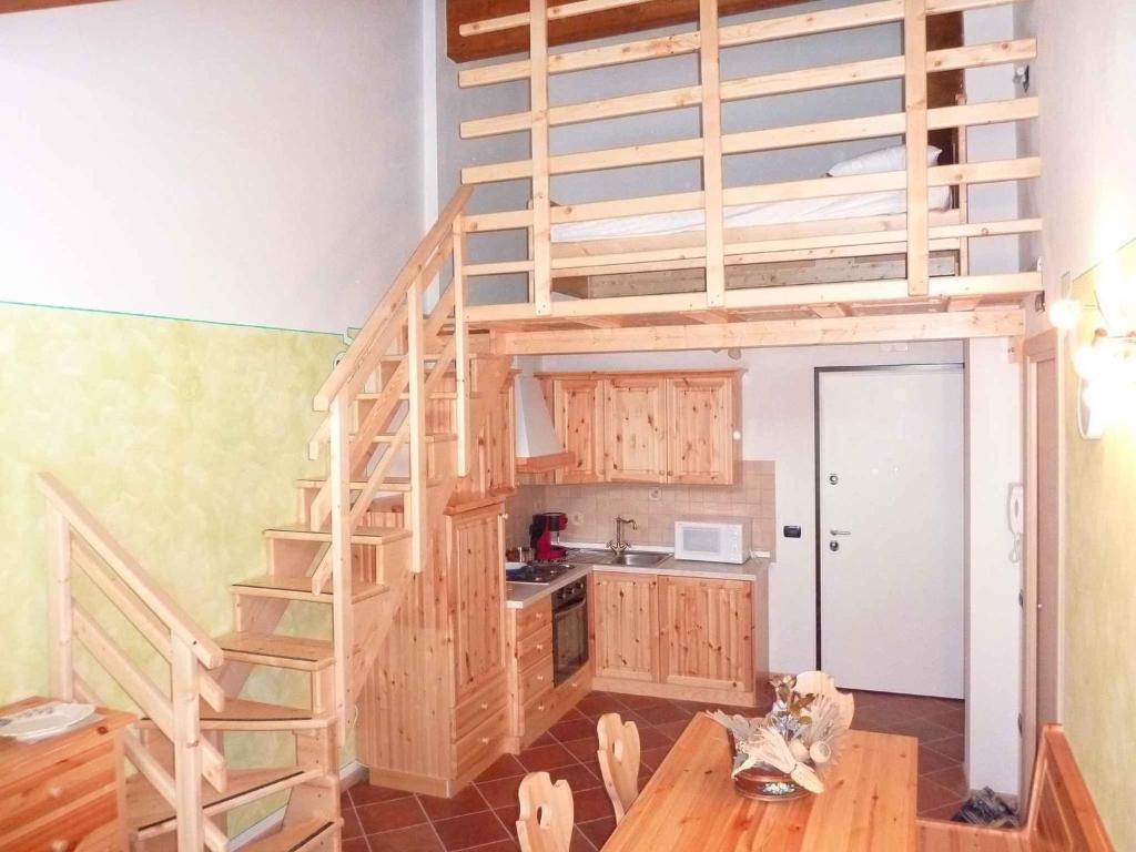 a kitchen with a loft bed in a room at Apartments in Comano 24163 in Comano Terme