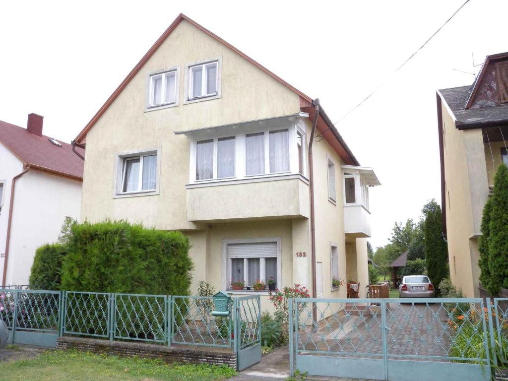 a house with a fence in front of it at Holiday home in Balatonfenyves 18432 in Balatonfenyves