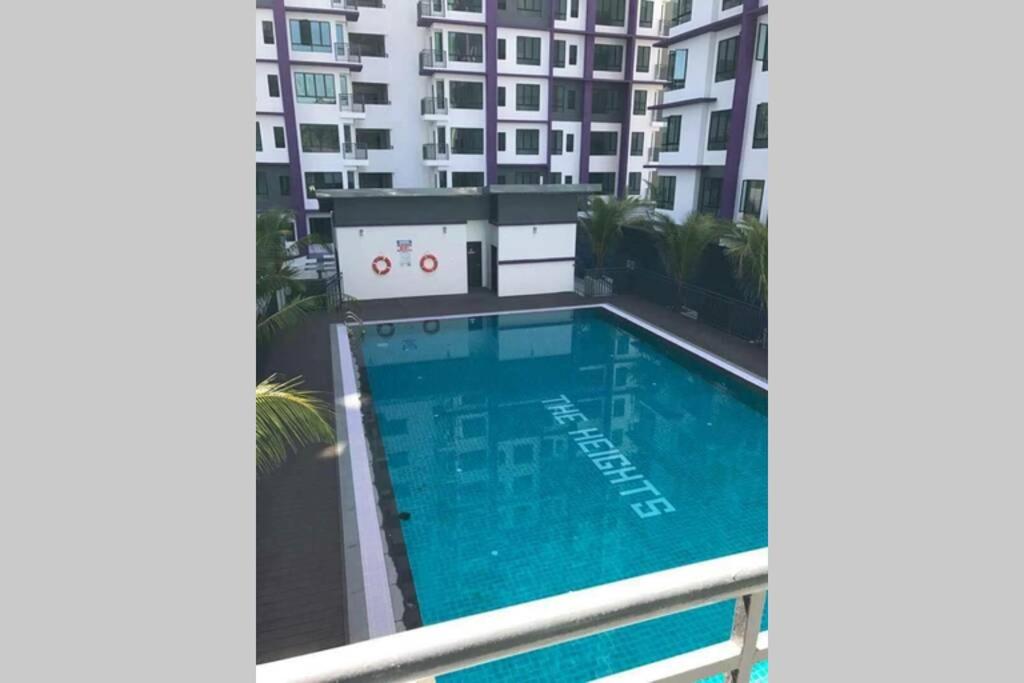 a swimming pool on the balcony of a building at KNM Homestay Melaka in Ayer Keroh