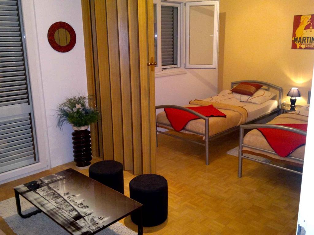 a small room with two beds and a table at Apartment in Njivice/Insel Krk 13324 in Njivice