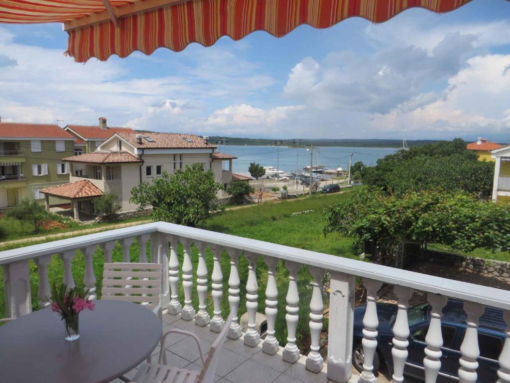 a balcony with a table and a view of the water at Apartment in Klimno/Insel Krk 12479 in Klimno