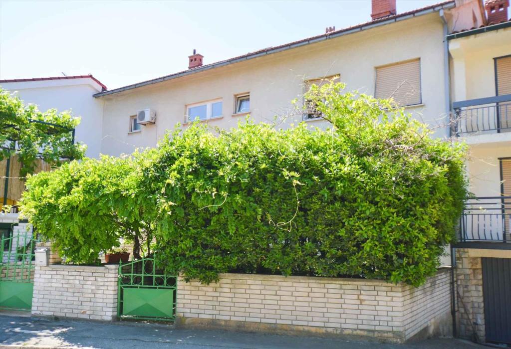 a building with a large bush on the side of it at Apartment in Pula/Istrien 17471 in Veruda