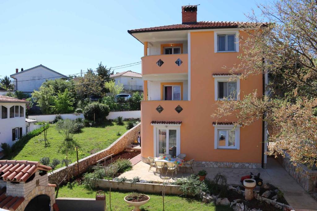 a large orange house with a yard and a patio at Apartment in Silo/Insel Krk 13586 in Šilo