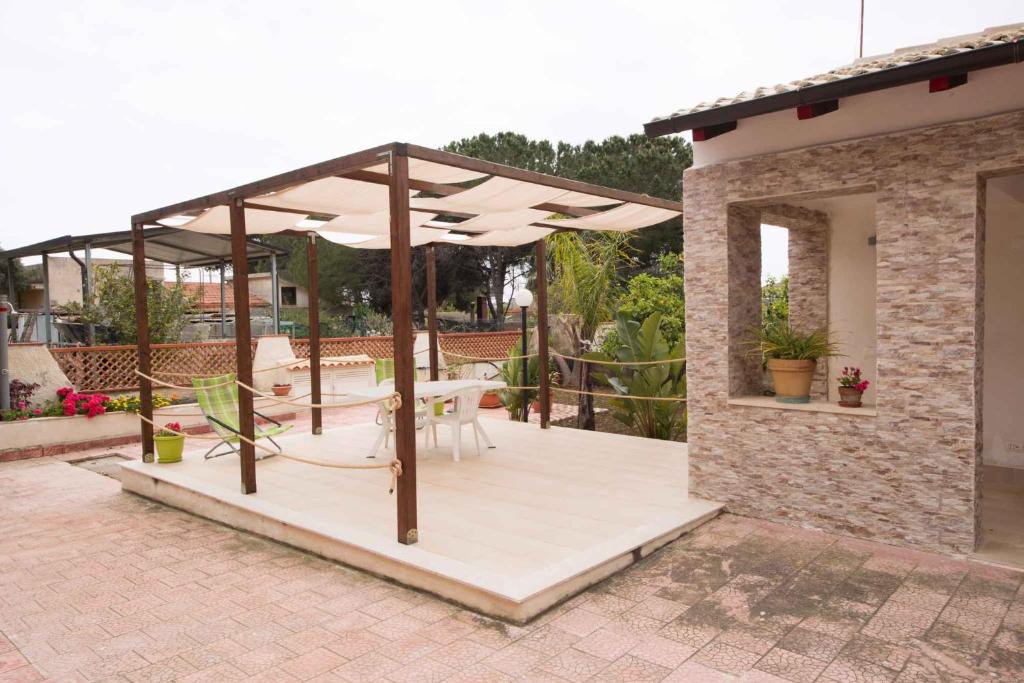 a patio with a table and umbrellas at Two-Bedroom Apartment in Siracusa II in Ognina