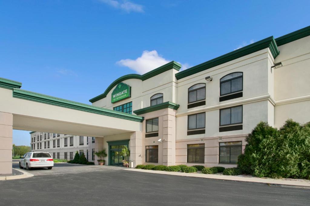 a hotel with a car parked in front of it at Wingate by Wyndham Green Bay in Green Bay