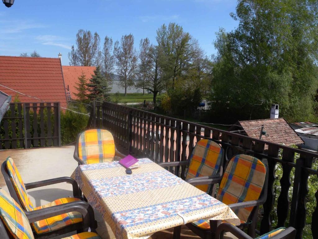 an outdoor table and chairs on a balcony at Two-Bedroom Apartment in Balatonbereny II in Balatonberény