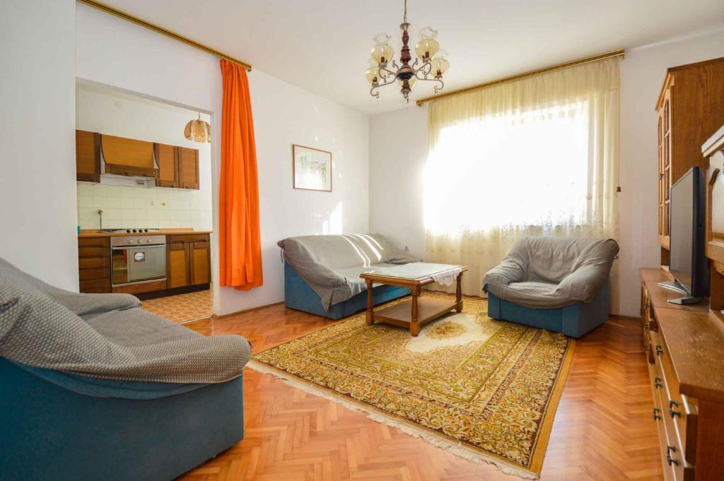 a living room with a couch and chairs and a table at Two-Bedroom Apartment in Pula IX in Veruda
