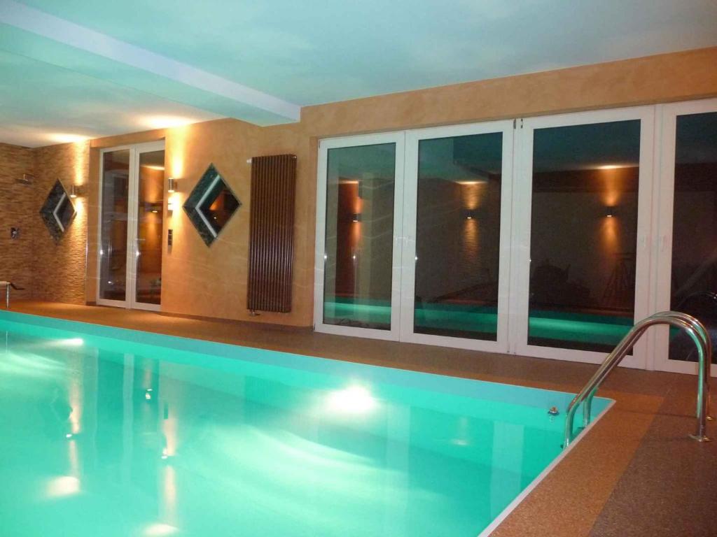 a large swimming pool in a building with windows at Holiday home in Coswig 3105 in Möllensdorf
