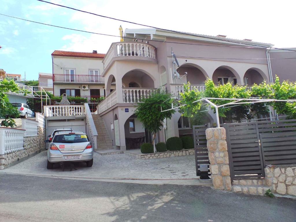 a house with a car parked in front of it at Apartment Crikvenica, Vinodol 8 in Crikvenica