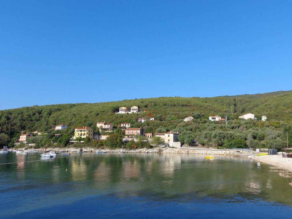 a group of houses on the shore of a body of water at Apartment Sv. Marina 1 in Sveta Marina