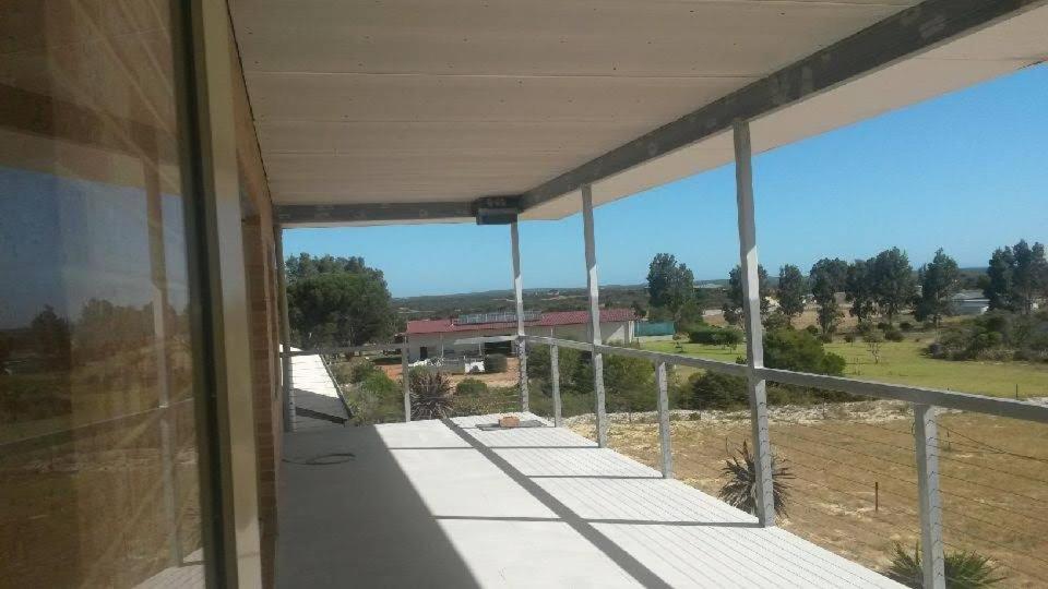 a balcony of a house with a view of a field at Turquoise Coast Fishing Lodge in Jurien Bay