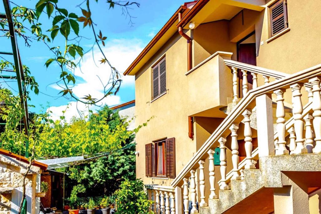 a house with a staircase in front of it at Apartment Pula, Brijuni, Istria 2 in Veruda