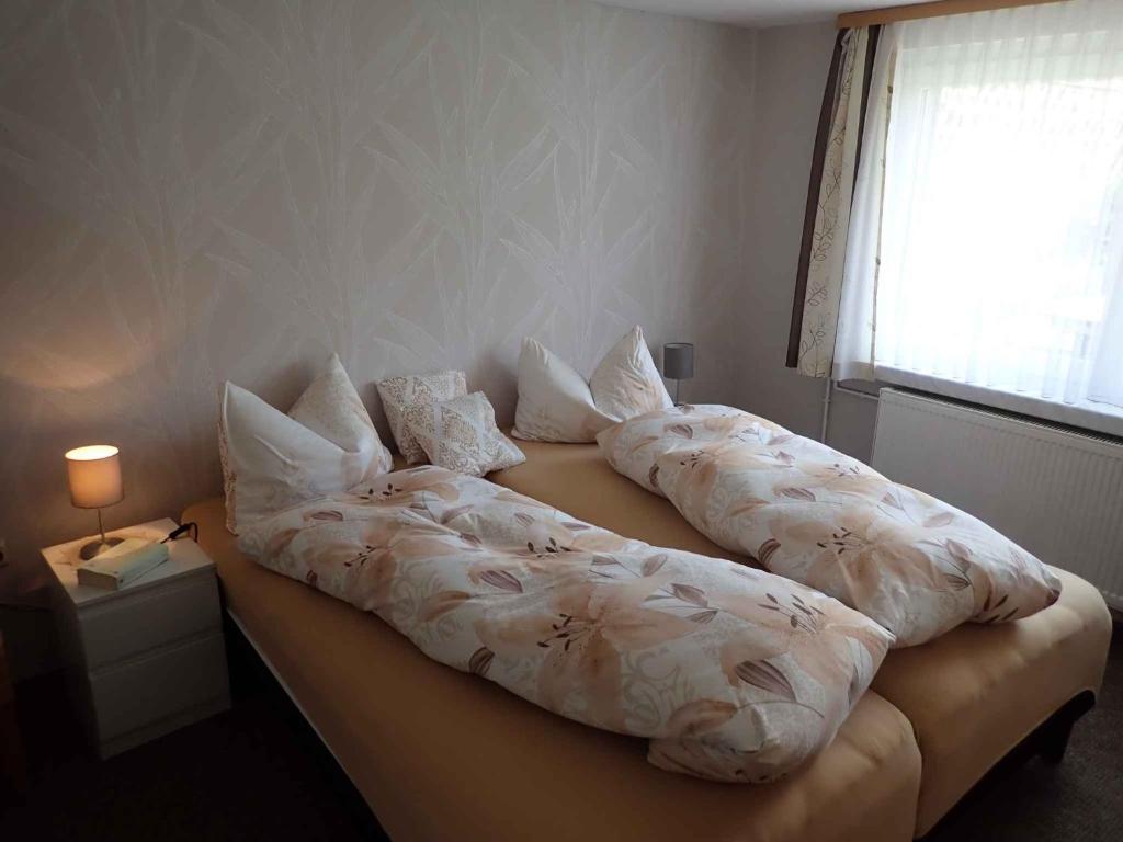 two pillows on a bed in a bedroom at Apartment in Wutha-Farnroda 3178 in Mosbach