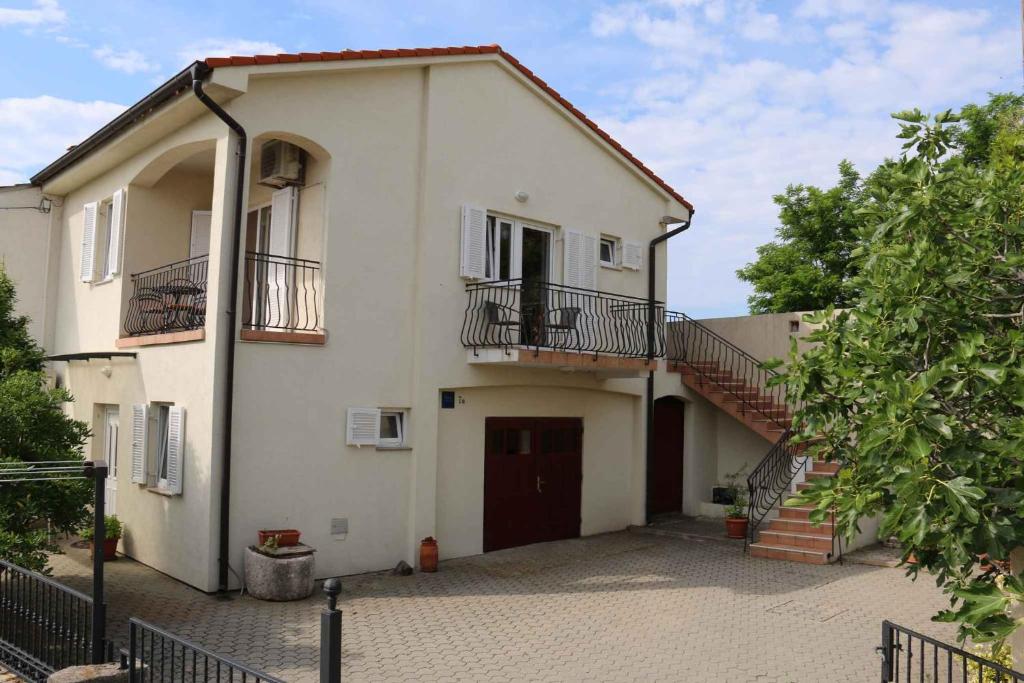 a large white house with a staircase on the side at Apartment in Silo/Insel Krk 13433 in Šilo