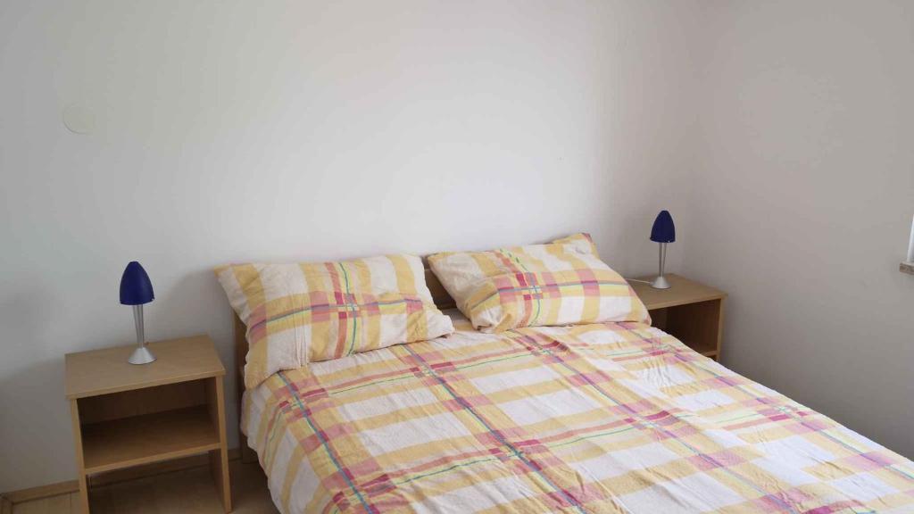 a bedroom with a bed and two night stands at Apartment Silo 3 in Šilo