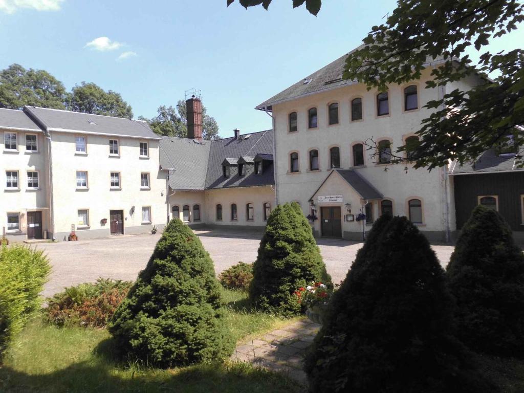 a large white building with trees in front of it at Apartment Sayda 4 in Pilsdorf